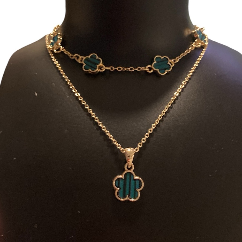 Gold  clover with green and black striped enamel.